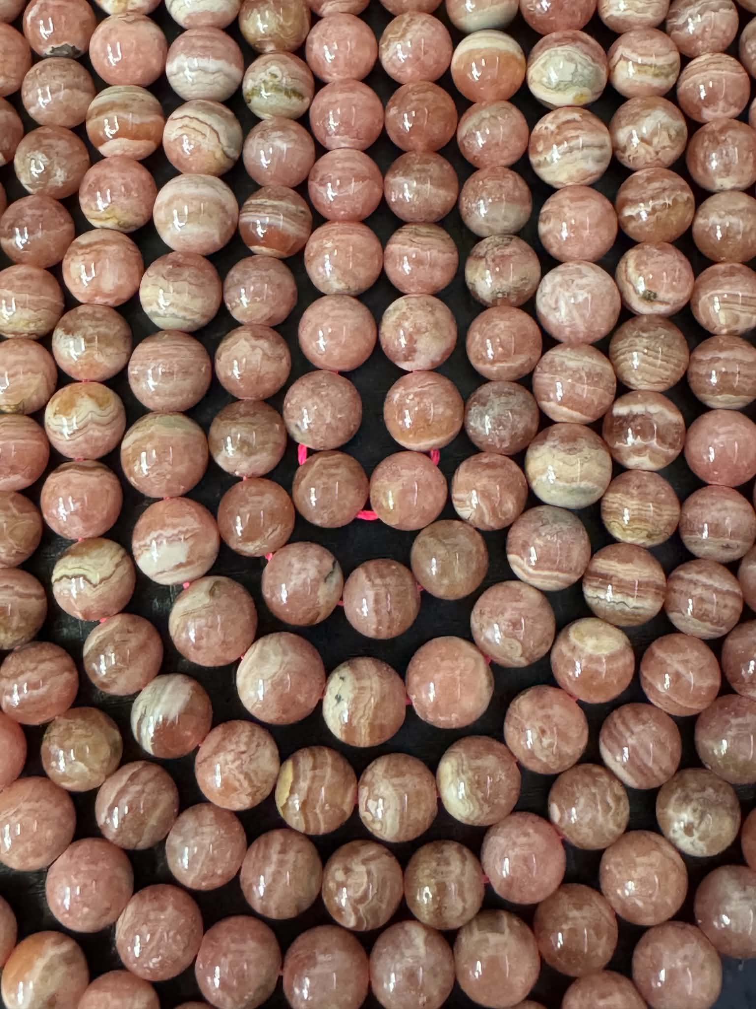 Rhodochrosit ca. 7.5mm Kugelstrang. Alte, schöne Qualität aus Argentinien